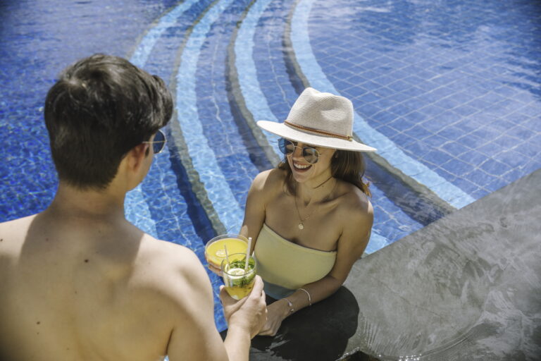 Couple drinking a cocktail in the pool at Tamassa. Mauritius Holidays for Couples