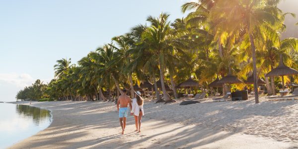 Couple on the beach at LUX* Le Morne. Mauritius holidays for couples.